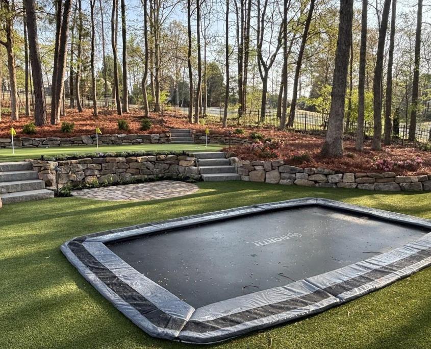 Turf backyard with built in trampoline
